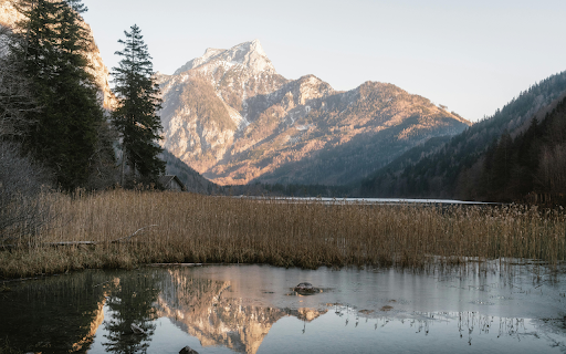 Serene Mountain Lake Reflection in Austria  from Chrome web store to be run with OffiDocs Chromium online