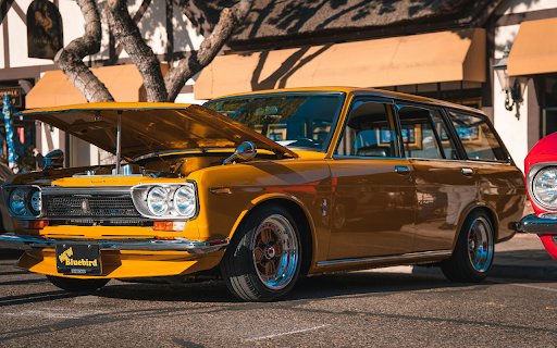 Shiny Yellow Station Wagon Parked Beside a Tree  from Chrome web store to be run with OffiDocs Chromium online Shiny Yellow Station Wagon Parked Beside a Tree  from Chrome web store to be run with OffiDocs Chromium online