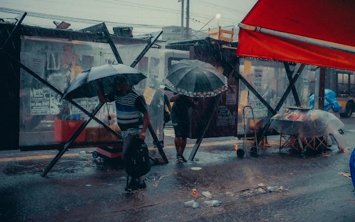 Umbrellas Walking on a Sidewalk in City in Heavy Rain  from Chrome web store to be run with OffiDocs Chromium online