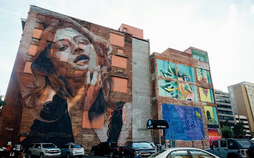 Vehicles Park Near Wall With Woman Graffiti  from Chrome web store to be run with OffiDocs Chromium online