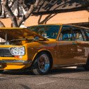 Shiny Yellow Station Wagon Parked Beside a Tree  screen for extension Chrome web store in OffiDocs Chromium
