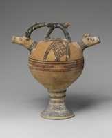 Free download Terracotta vase on a high foot with two goats heads in relief free photo or picture to be edited with GIMP online image editor