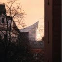 The sun is setting over a building with a large roof  screen for extension Chrome web store in OffiDocs Chromium