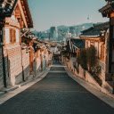 Traditional Village Lane Leading to Modern Skyline  screen for extension Chrome web store in OffiDocs Chromium