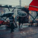 Umbrellas Walking on a Sidewalk in City in Heavy Rain  screen for extension Chrome web store in OffiDocs Chromium