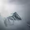 A mountain is seen in the clouds with a cloudy sky  screen for extension Chrome web store in OffiDocs Chromium