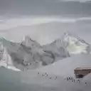 A snowy mountain with a cabin in the middle  screen for extension Chrome web store in OffiDocs Chromium