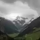 A valley with mountains and clouds in the background  screen for extension Chrome web store in OffiDocs Chromium