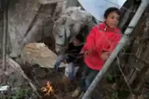 Free download Palestinian children warm up in front of a fire in a hovel during the cold and rainy weather in the Jabalia refugee camp in the northern Gaza Strip on January 1, 2018. free photo or picture to be edited with GIMP online image editor