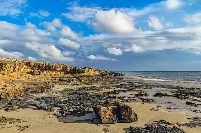 Free download rocky coast sea beach sky clouds free picture to be edited with GIMP free online image editor