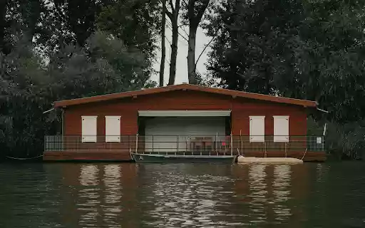 A houseboat on the water with a dock  from Chrome web store to be run with OffiDocs Chromium online