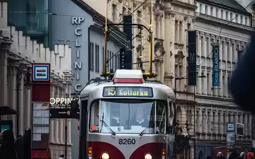 A red and white tram on a city street  from Chrome web store to be run with OffiDocs Chromium online