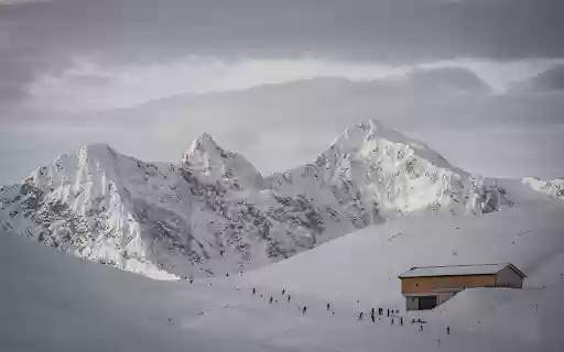 A snowy mountain with a cabin in the middle  from Chrome web store to be run with OffiDocs Chromium online