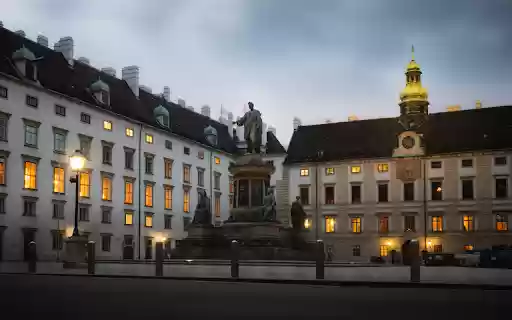 A statue is in front of a building at dusk  from Chrome web store to be run with OffiDocs Chromium online