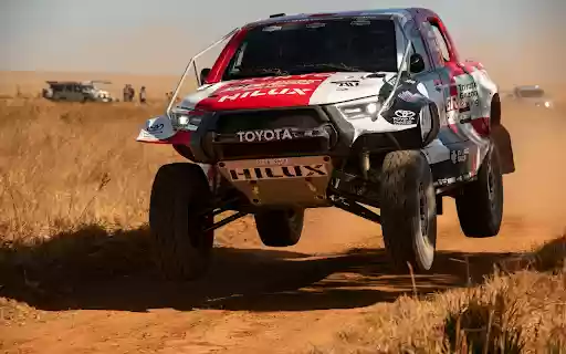A white car driving on a dirt road  from Chrome web store to be run with OffiDocs Chromium online