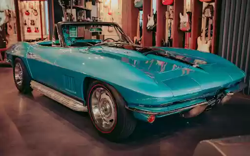 Blue Chevrolet Car Parked Inside the Guitar Store  from Chrome web store to be run with OffiDocs Chromium online
