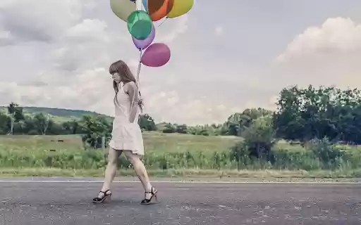 Girl holding balloons  from Chrome web store to be run with OffiDocs Chromium online