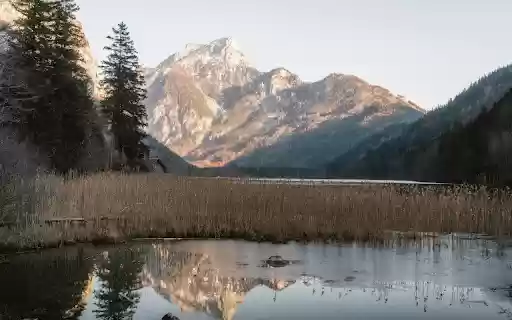 Serene Mountain Lake Reflection in Austria  from Chrome web store to be run with OffiDocs Chromium online