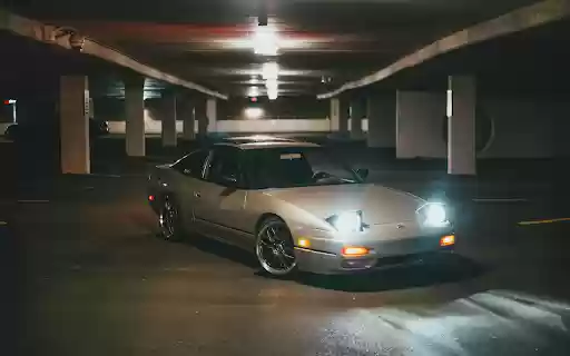 Silver Car Parked with Lights On  from Chrome web store to be run with OffiDocs Chromium online