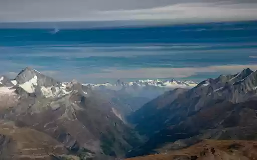 Snow Covered Mountains Under Blue Sky  from Chrome web store to be run with OffiDocs Chromium online