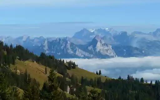 Stunning View of Swiss Alps with Foggy Landscape  from Chrome web store to be run with OffiDocs Chromium online