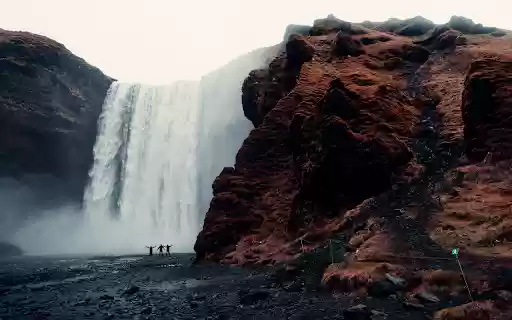 Three Men Standing Near Waterfalls  from Chrome web store to be run with OffiDocs Chromium online