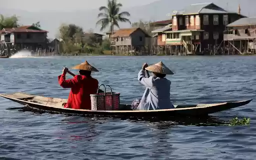 Two people rowing a boat by the river  from Chrome web store to be run with OffiDocs Chromium online