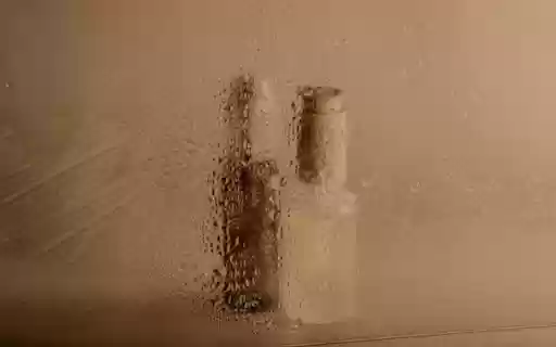 Two Skincare Bottles in a Steamy Mirror Reflection  from Chrome web store to be run with OffiDocs Chromium online