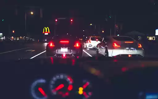 Various modern vehicles riding on street at night  from Chrome web store to be run with OffiDocs Chromium online
