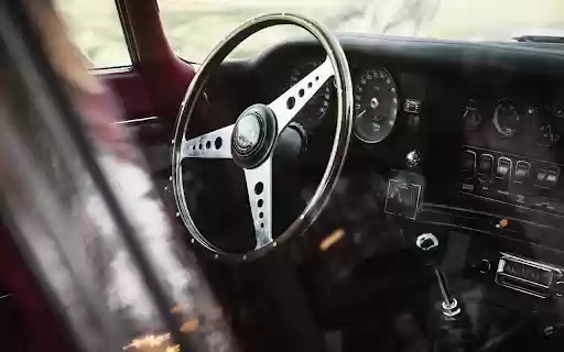 Vintage Car Interior with Steering Wheel and Dashboard  from Chrome web store to be run with OffiDocs Chromium online