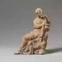 Free download Terracotta statuette of a woman seated on a rock free photo or picture to be edited with GIMP online image editor