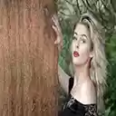 Very attractive model leaning on a tree  screen for extension Chrome web store in OffiDocs Chromium